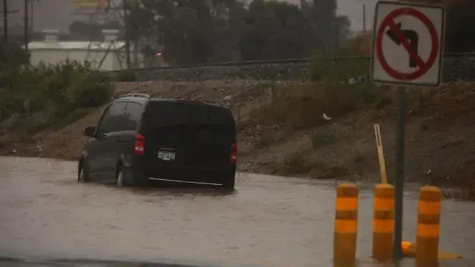 A van stopped in floodwater on a road during a winter storm near Carson